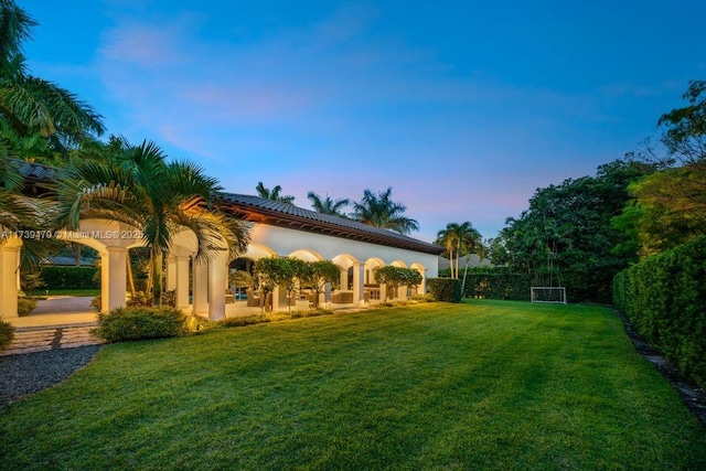 yard at dusk with a patio