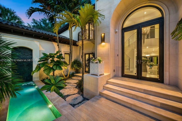 exterior entry at dusk with french doors