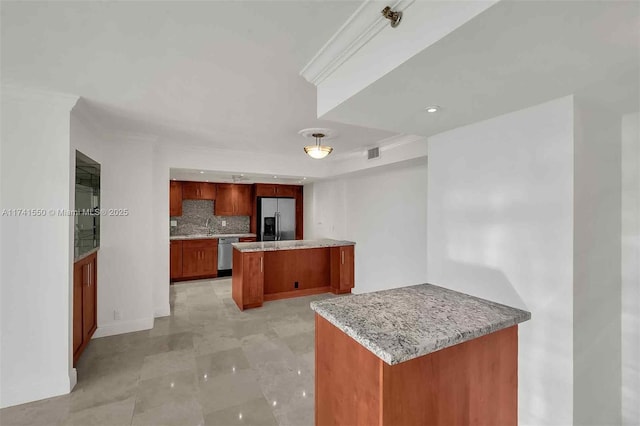 kitchen with tasteful backsplash, crown molding, stainless steel appliances, and kitchen peninsula