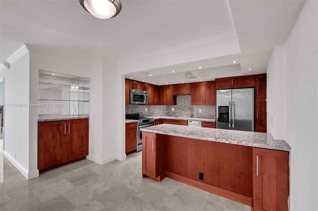 2000 Towerside Ter Unit 910, Miami, FL 33138 - kitchen featuring appliances with stainless steel finishes, a peninsula, a raised ceiling, tasteful backsplash, and baseboards