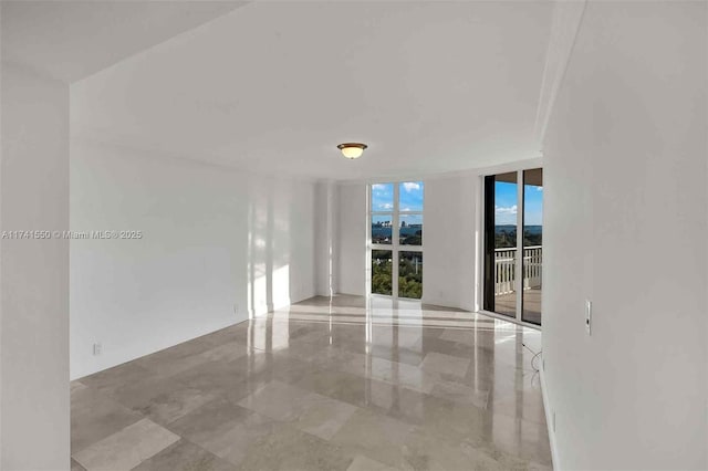 unfurnished room with floor to ceiling windows