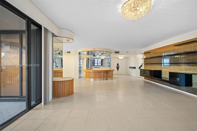 corridor with a notable chandelier and light tile patterned floors