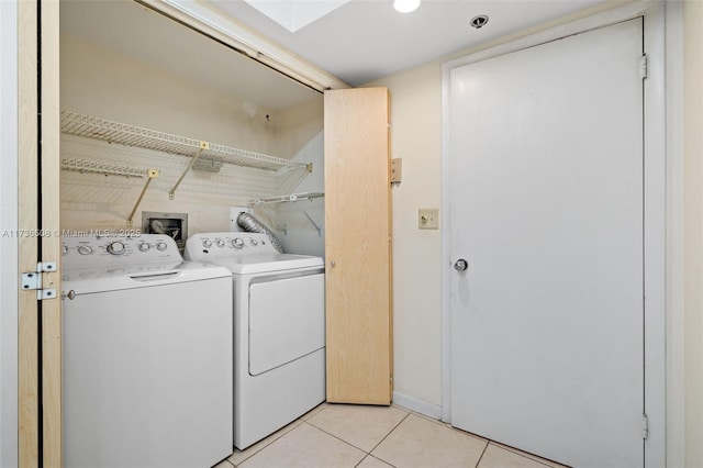 washroom with light tile patterned floors and washing machine and clothes dryer