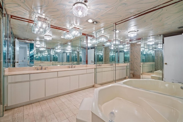 bathroom featuring vanity, a tub to relax in, and tile patterned flooring