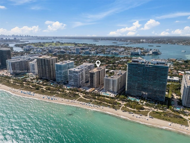 birds eye view of property featuring a water view and a beach view