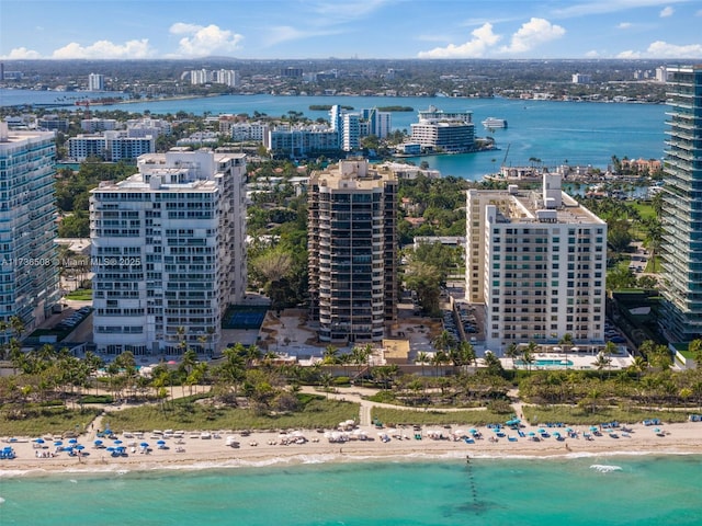 birds eye view of property with a beach view and a water view