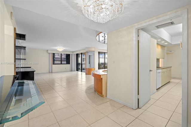 hall featuring a chandelier and light tile patterned floors