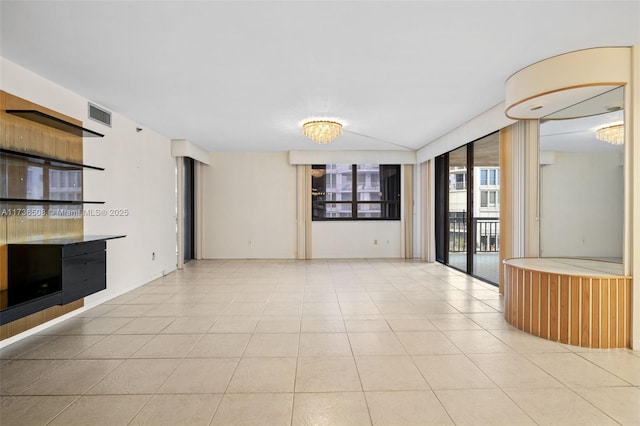 unfurnished living room with lofted ceiling and light tile patterned floors