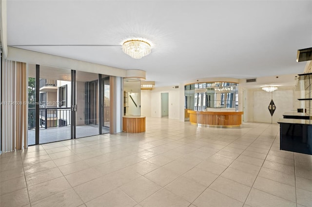 unfurnished room with light tile patterned flooring, floor to ceiling windows, and a notable chandelier