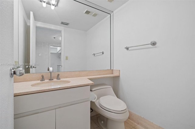 bathroom featuring tile patterned floors, toilet, and vanity