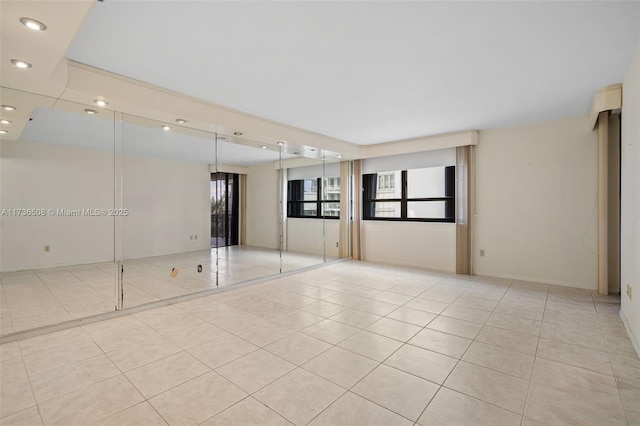 unfurnished room featuring light tile patterned floors