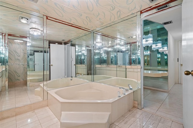 bathroom featuring tile patterned flooring, a bath, and vanity