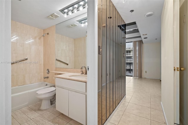 full bathroom with tiled shower / bath combo, vanity, tile patterned flooring, and toilet