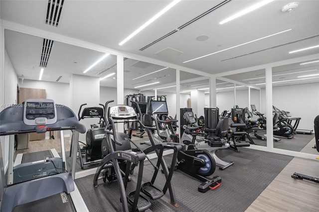 exercise room with hardwood / wood-style floors