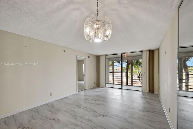 unfurnished room with expansive windows, a wealth of natural light, and a textured ceiling