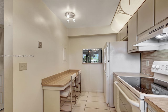 kitchen with light tile patterned flooring, white electric stove, and backsplash