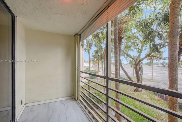 unfurnished sunroom featuring a balcony