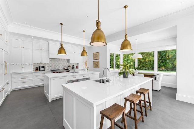 5501 Snapper Creek Rd, Coral Gables, FL 33156 - kitchen with a sink, ornamental molding, backsplash, and a center island with sink