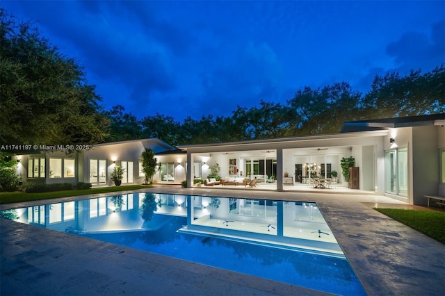 5501 Snapper Creek Rd, Coral Gables, FL 33156 - pool at night featuring ceiling fan, an outdoor pool, french doors, and a patio area