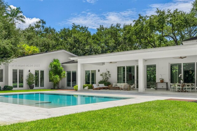 5501 Snapper Creek Rd, Coral Gables, FL 33156 - rear view of house with outdoor lounge area, a ceiling fan, an outdoor pool, and a patio area