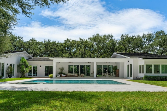 5501 Snapper Creek Rd, Coral Gables, FL 33156 - rear view of property with stucco siding, a yard, a patio, a ceiling fan, and an outdoor pool