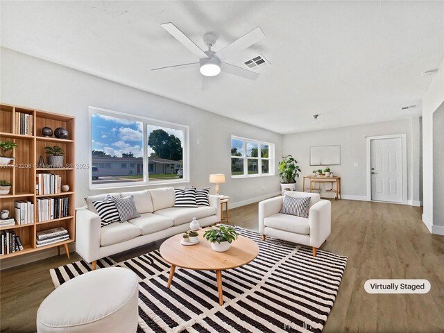 living room with hardwood / wood-style flooring and ceiling fan