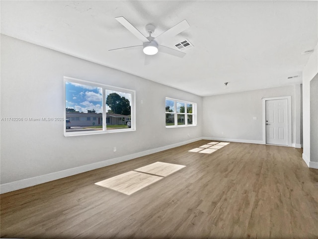 empty room featuring hardwood / wood-style flooring and ceiling fan