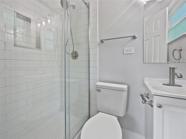 bathroom featuring vanity, toilet, and a shower with door