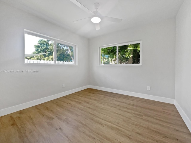 empty room with ceiling fan and light wood-type flooring