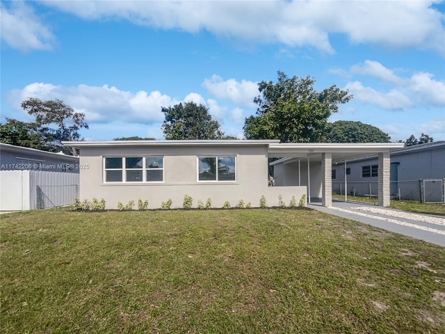 ranch-style home featuring a carport and a front yard