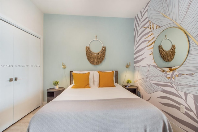 bedroom featuring light hardwood / wood-style floors and a closet