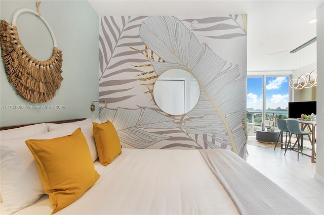 bedroom featuring light tile patterned flooring, a wall of windows, and access to exterior