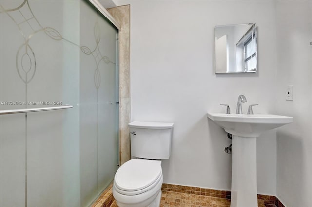 bathroom with sink, toilet, and walk in shower