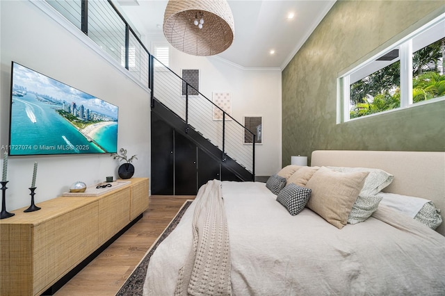 bedroom featuring recessed lighting, visible vents, crown molding, and wood finished floors