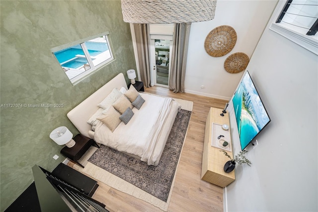 bedroom featuring light wood-style flooring and baseboards