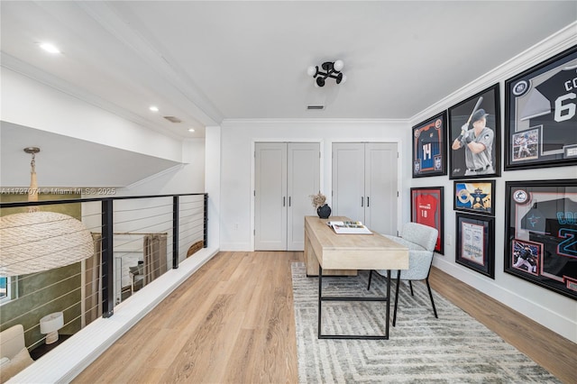 office space with crown molding, baseboards, and wood finished floors