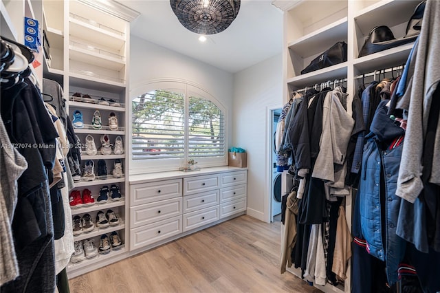 walk in closet featuring light wood finished floors