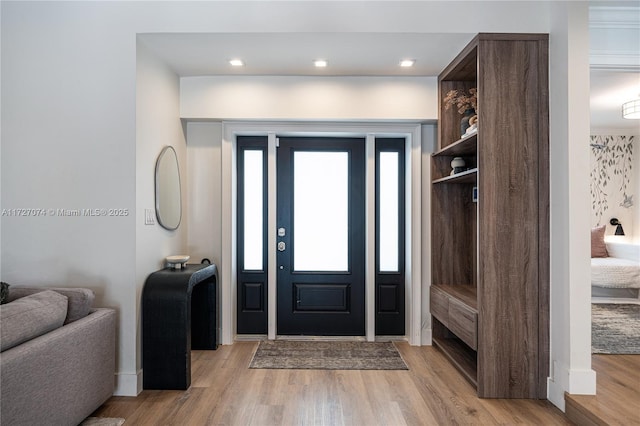 entrance foyer with light wood-style floors, recessed lighting, and baseboards