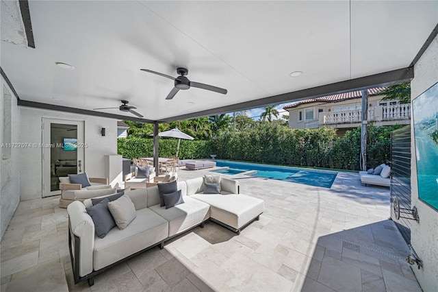 view of patio / terrace with an outdoor hangout area, ceiling fan, and a fenced in pool