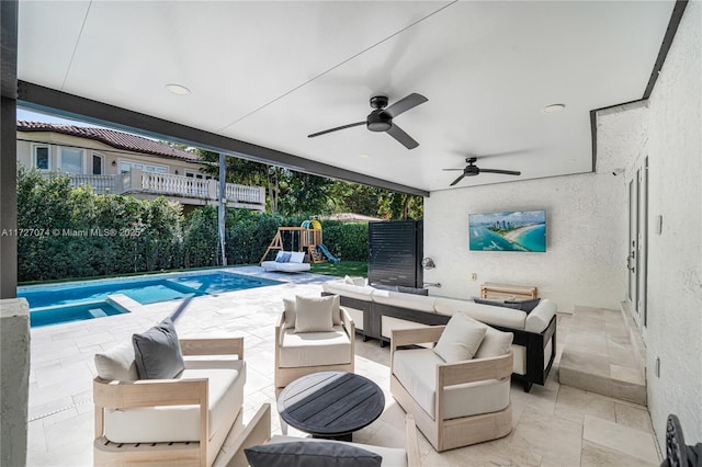 view of patio with a playground, ceiling fan, fence, and an outdoor hangout area