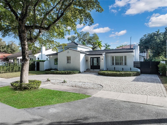 view of front of home with decorative driveway and stucco siding