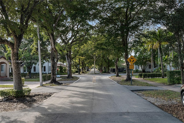 view of road featuring sidewalks and traffic signs