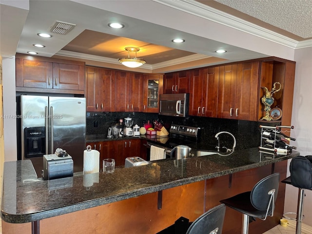 kitchen featuring a breakfast bar, sink, ornamental molding, kitchen peninsula, and stainless steel appliances