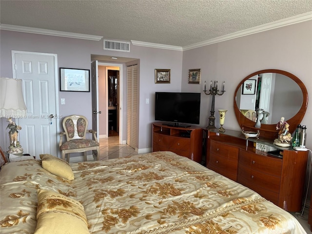 tiled bedroom with crown molding, a closet, and a textured ceiling