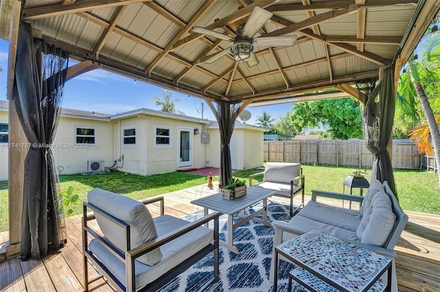 wooden deck with ceiling fan, a yard, a gazebo, ac unit, and an outdoor hangout area