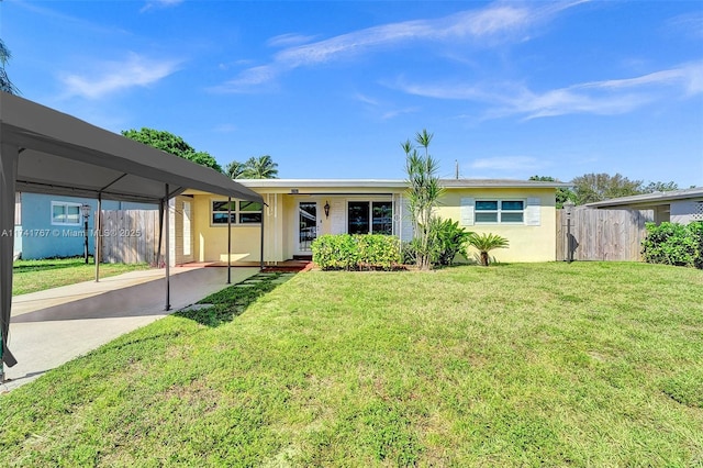 ranch-style house featuring a carport and a front lawn