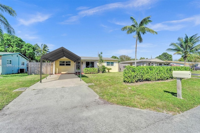 view of front of home with a front lawn and a carport