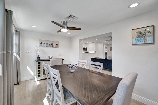 dining space featuring ceiling fan and light hardwood / wood-style flooring