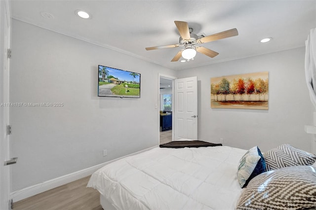 bedroom featuring ornamental molding, ceiling fan, and light hardwood / wood-style flooring