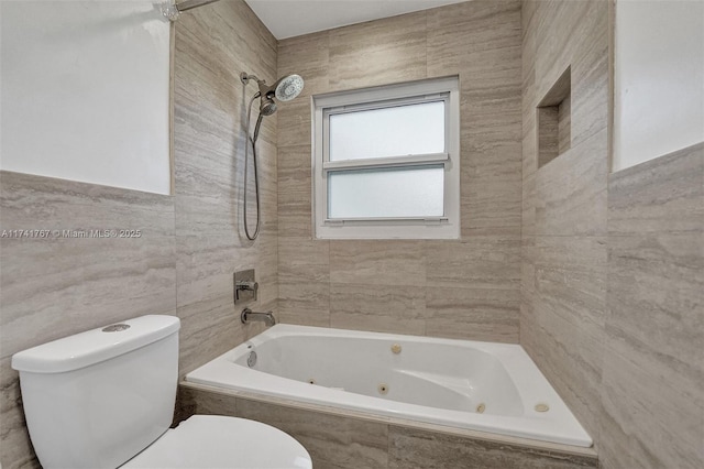 bathroom featuring tile walls, tiled shower / bath combo, and toilet